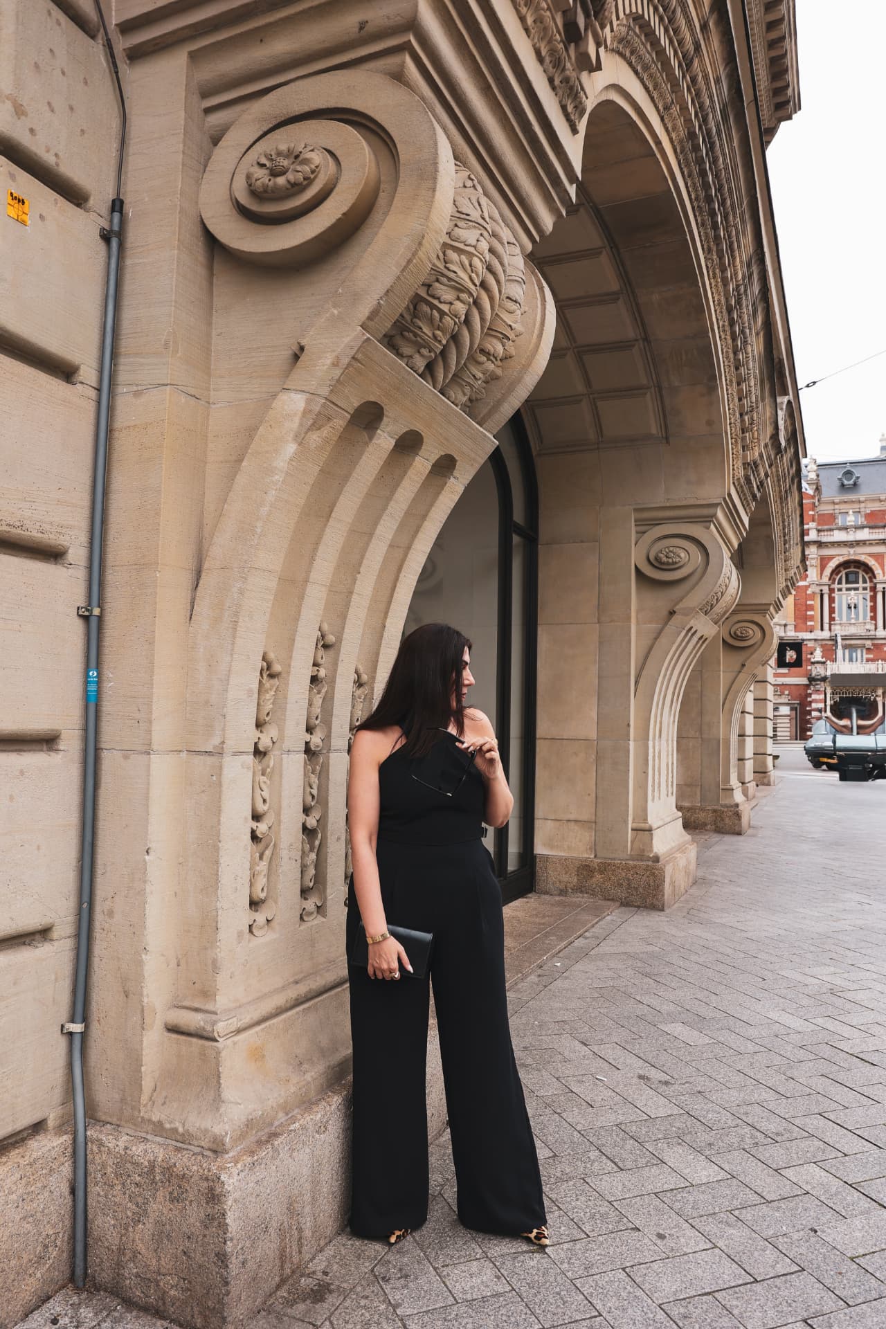 Hatice Tekin standing beside a monumental stone arch